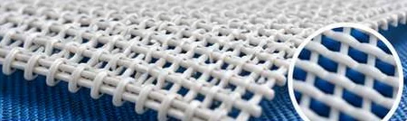 White synthetic forming wire over a blue backing fabric